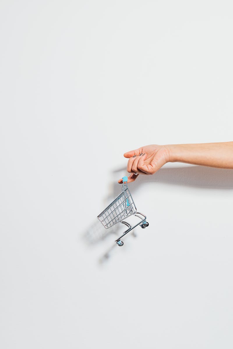 Tiny Shopping Cart Hanging on a Finger