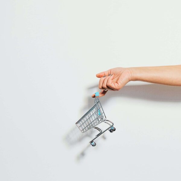 Tiny Shopping Cart Hanging on a Finger